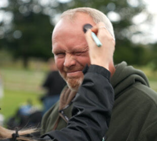 Photo of Rob Nicholson having make up applied before filming